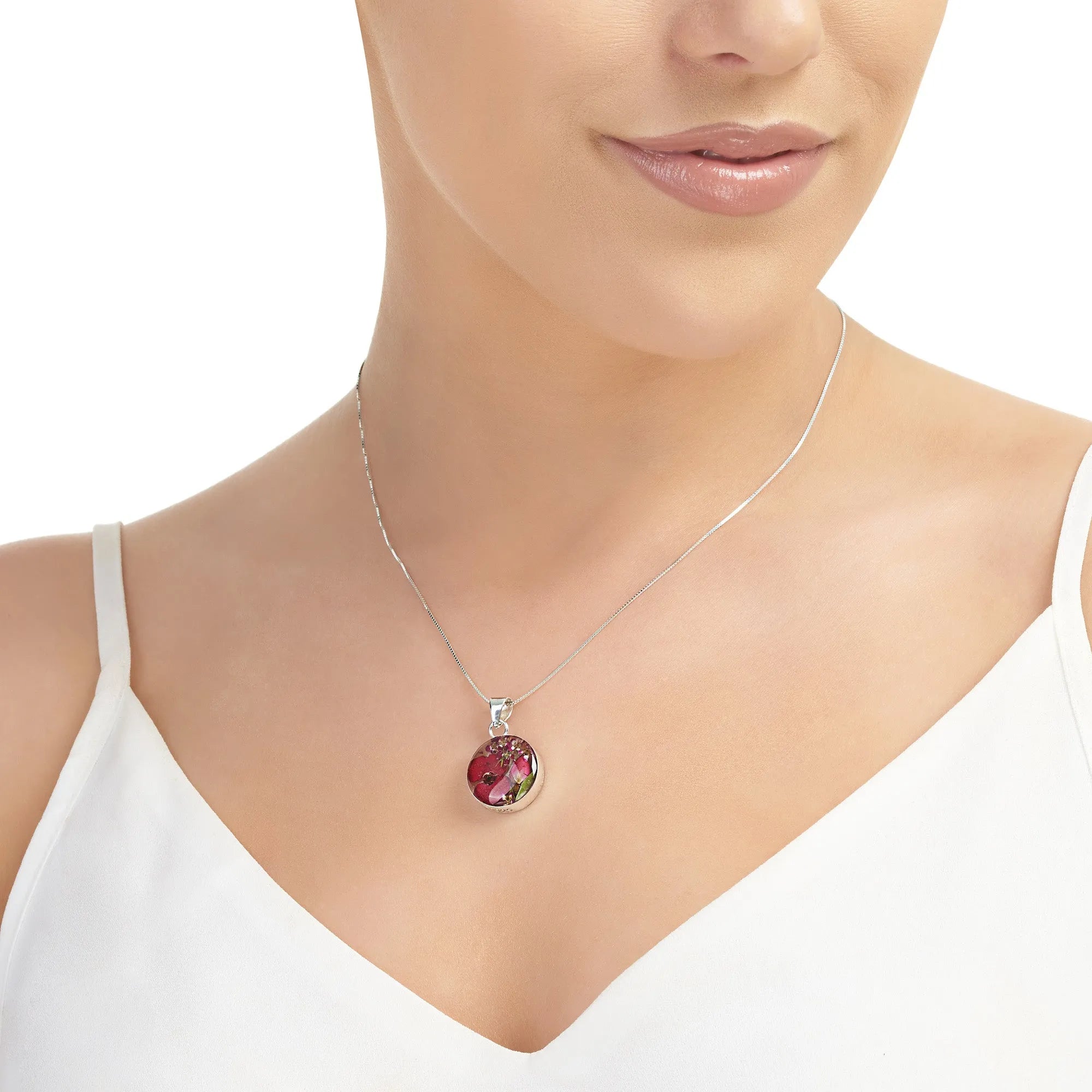 Piccolo ciondolo rotondo con veri fiori di Euphorbia – Argento